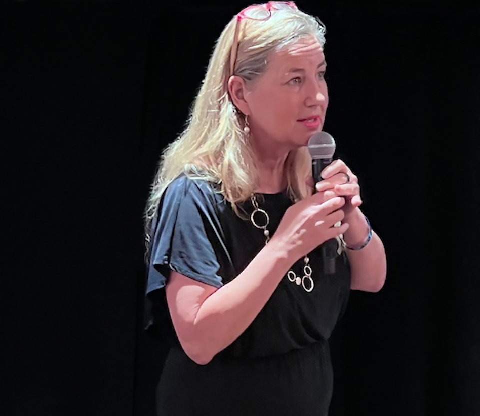 Kimberly speaking on stage